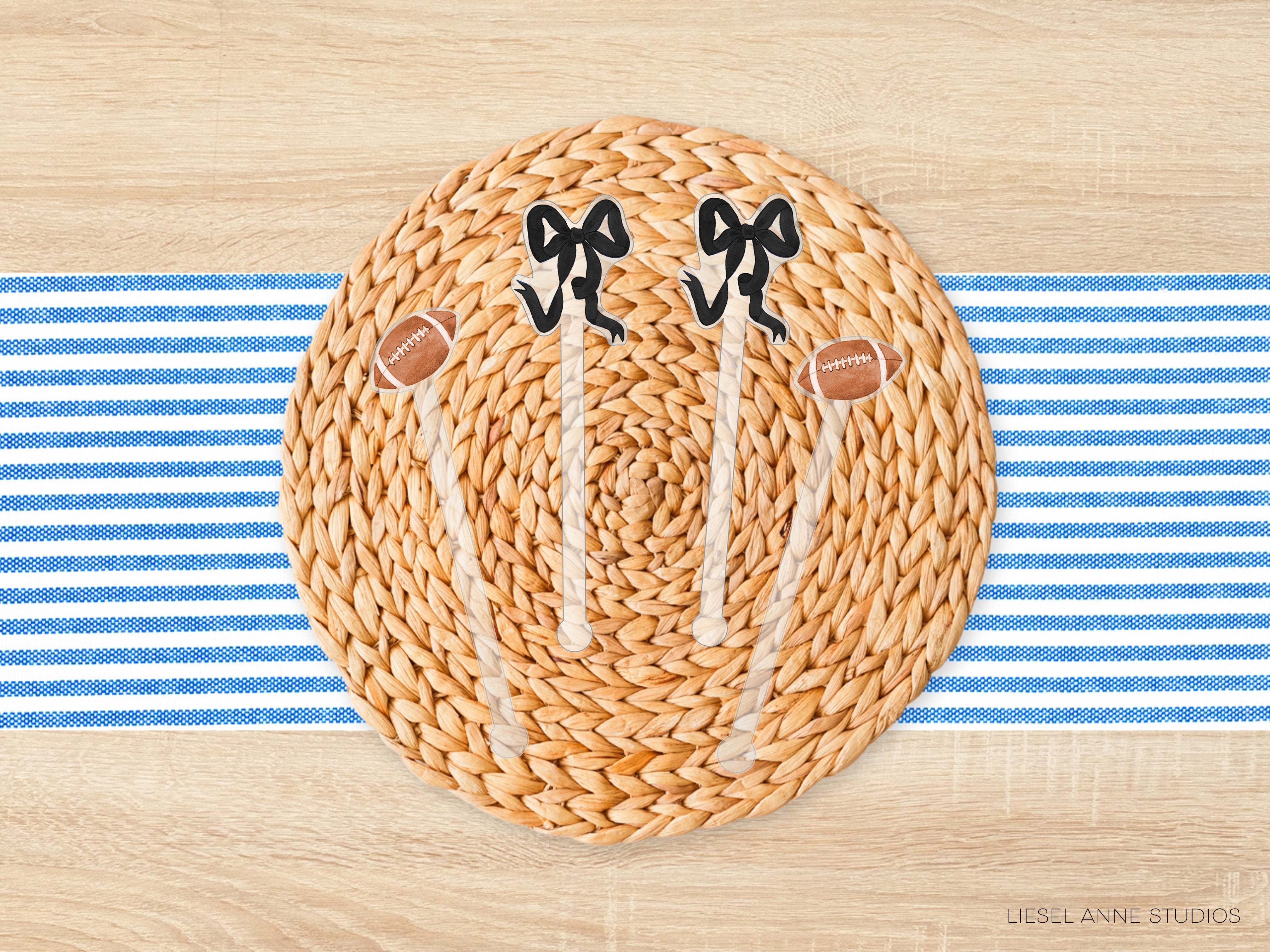 A woven placemat with a football and two bows on it, placed on a blue and white striped tablecloth.