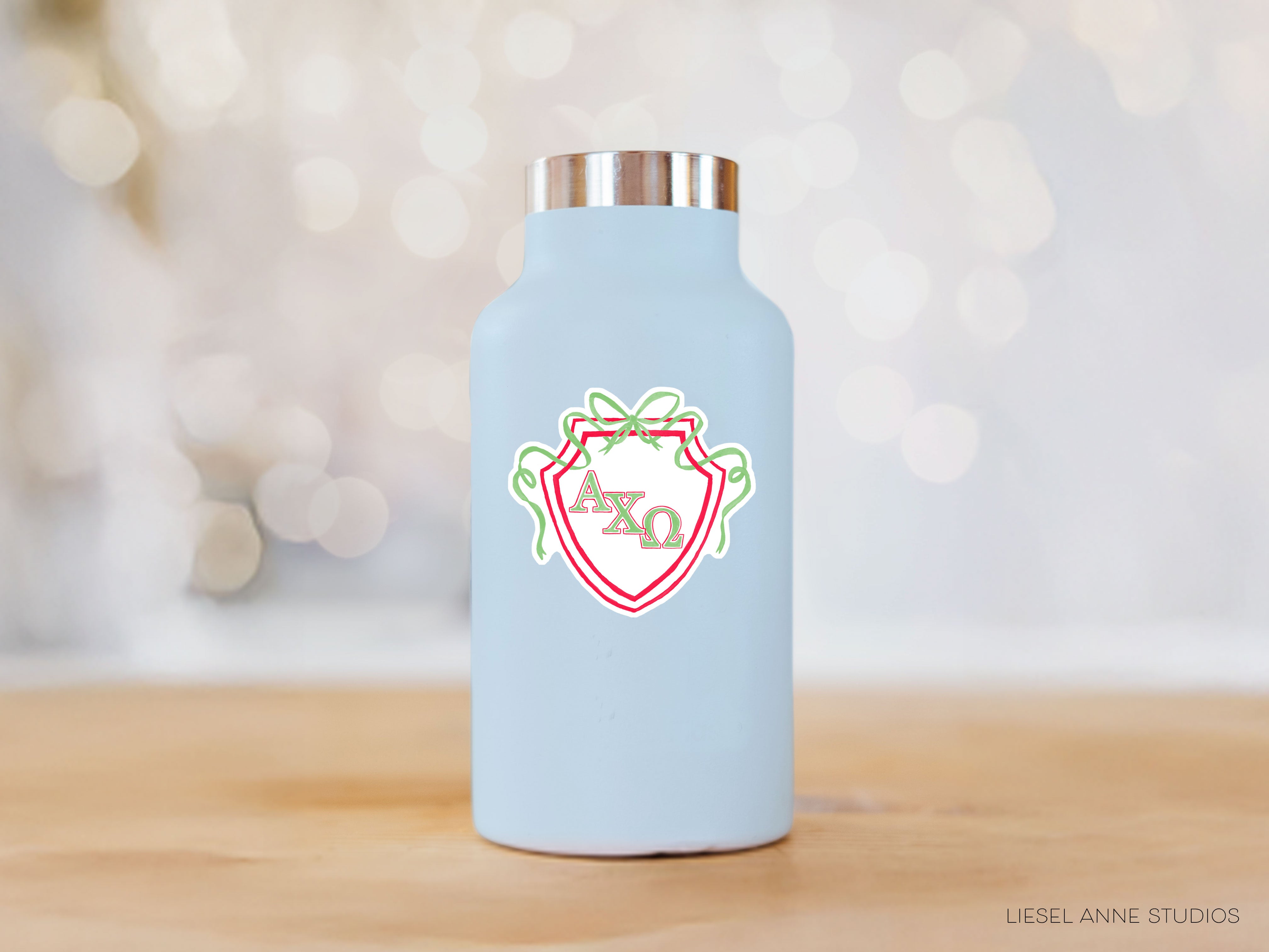 a blue water bottle with a red and green design on it