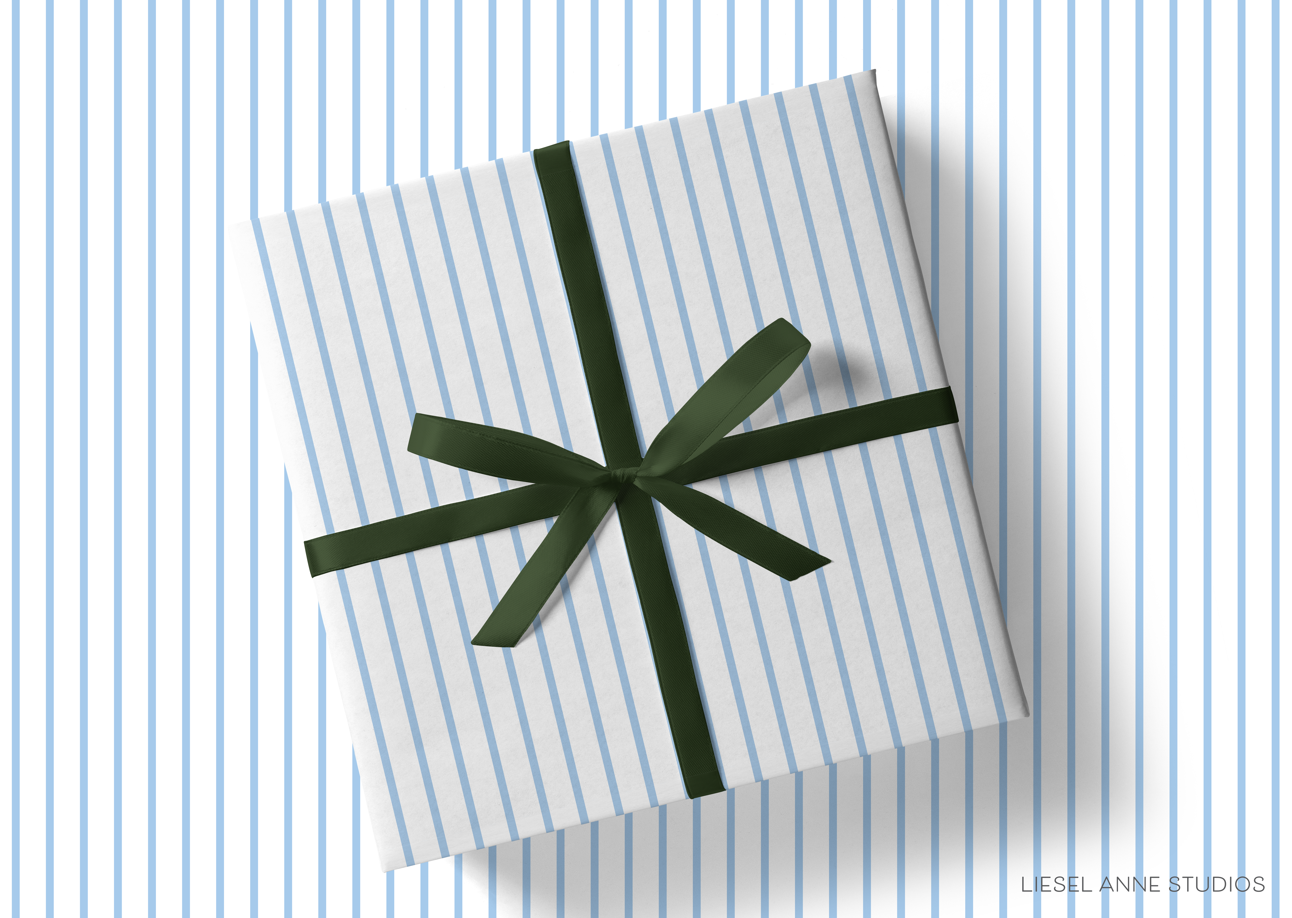 A gift box with a green ribbon tied around it, placed on a striped background.