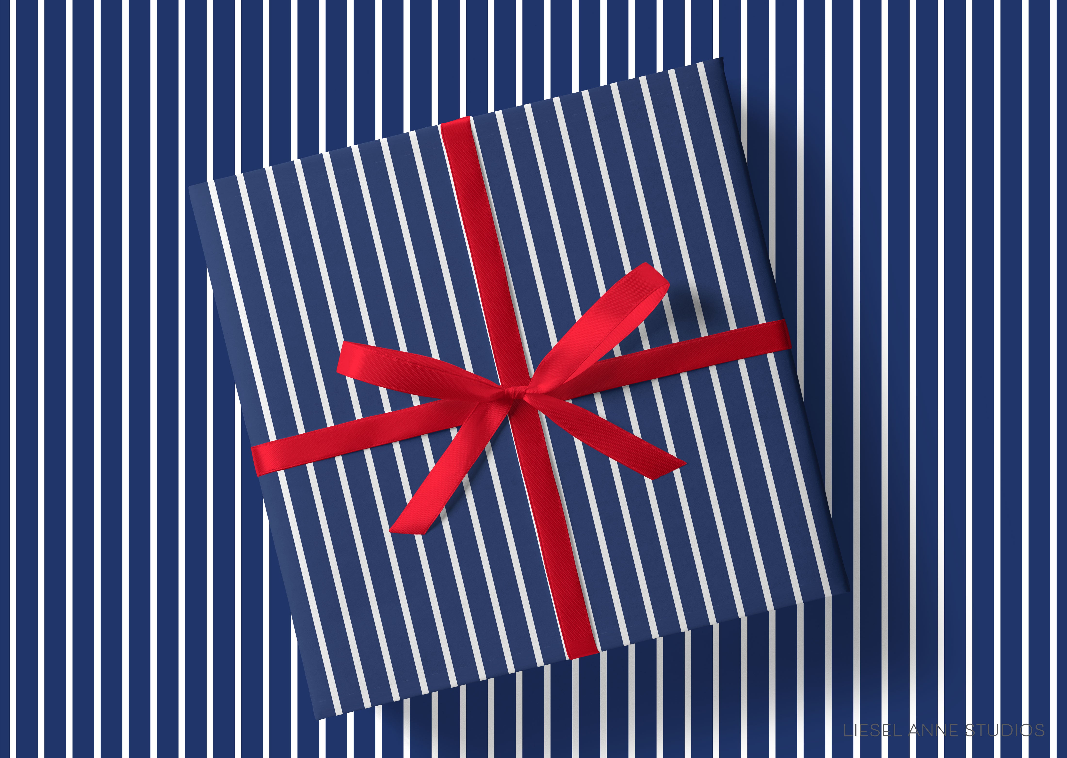 A gift box with a red ribbon tied around it, placed against a background of blue and white striped vertical lines.