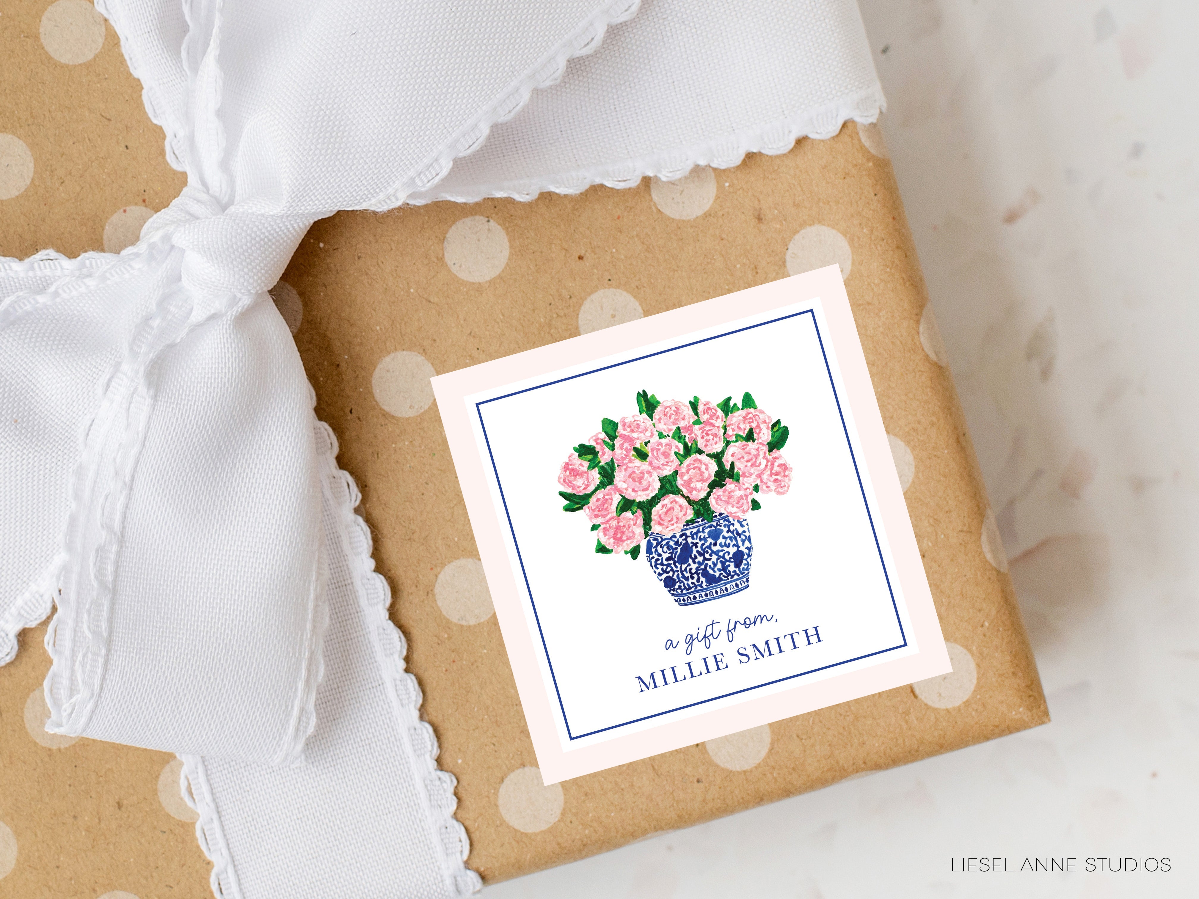 a gift wrapped in brown paper with pink flowers