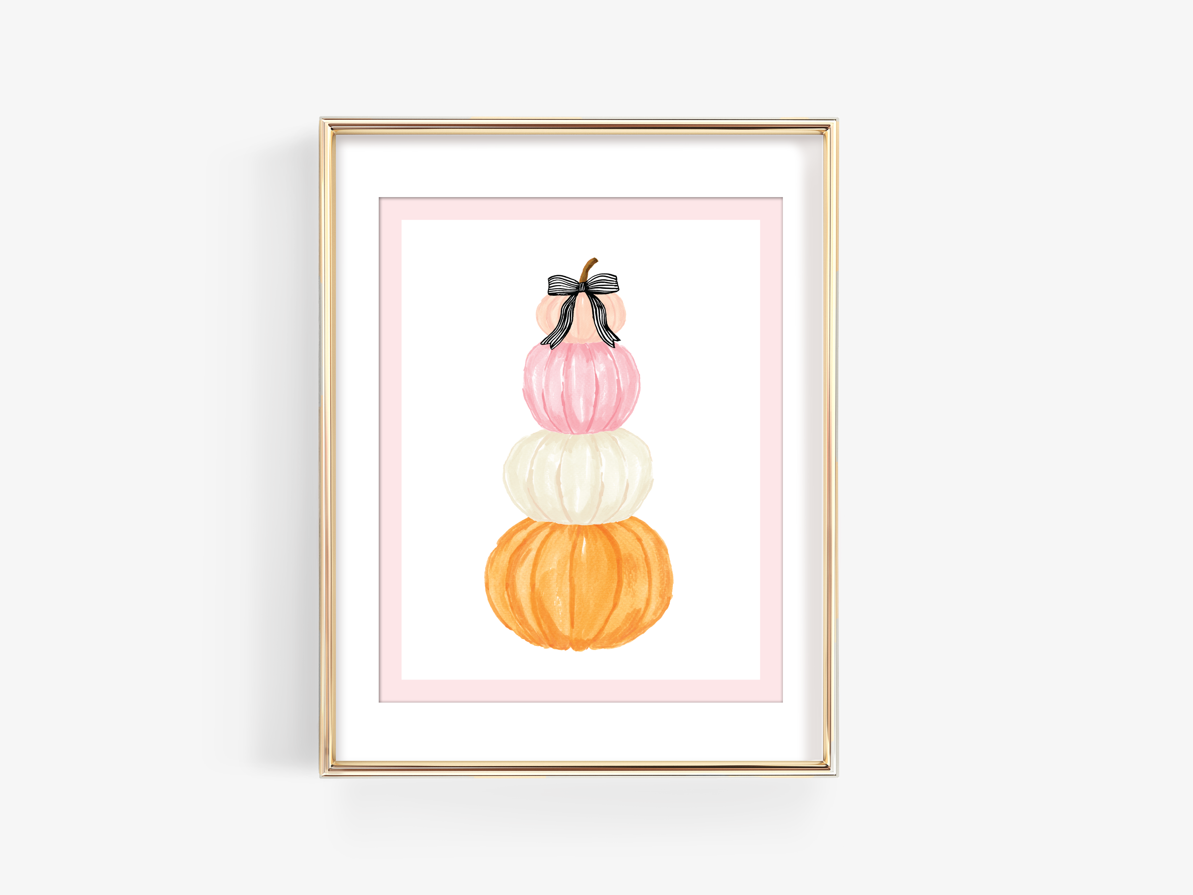 A framed illustration of a stack of three pumpkins in various colors, including pink, white, and orange.