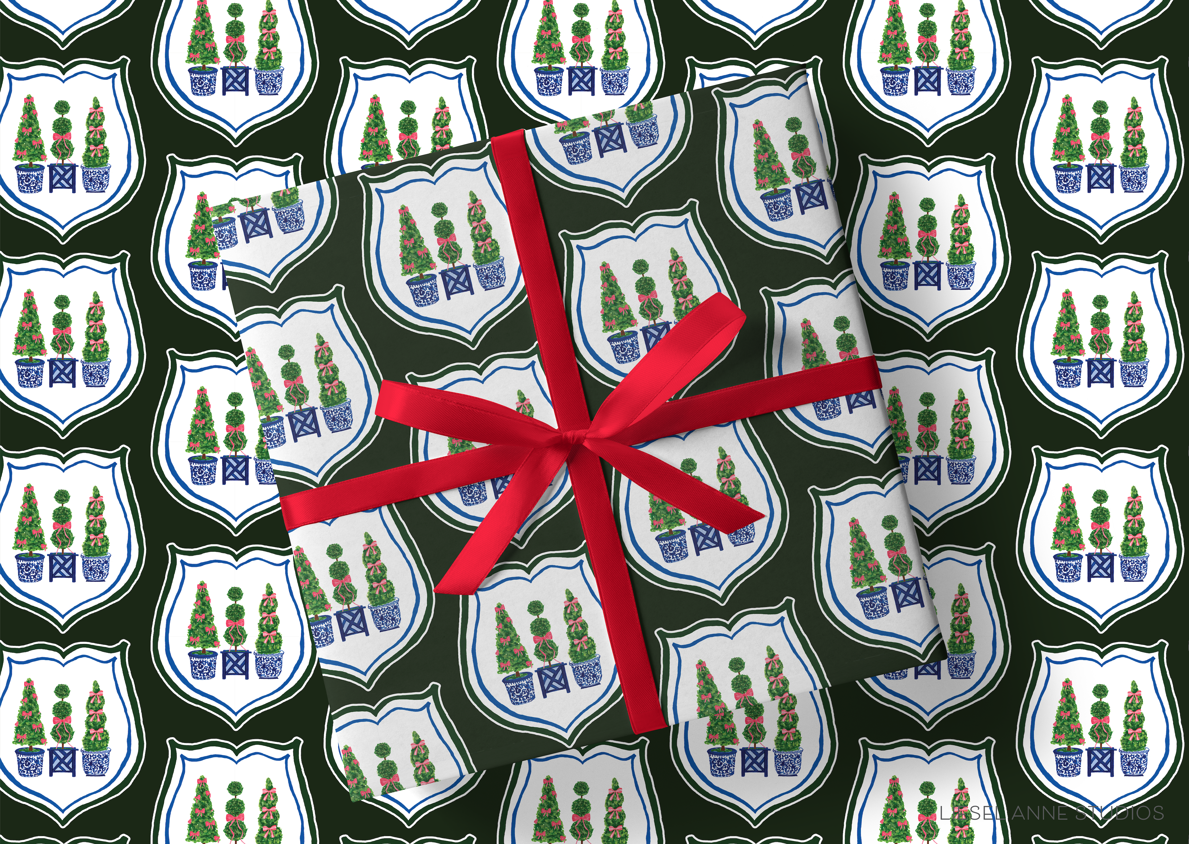a gift wrapped in a red ribbon, with a repeating pattern of green and white shields adorned with red and blue Christmas trees on a dark green background.