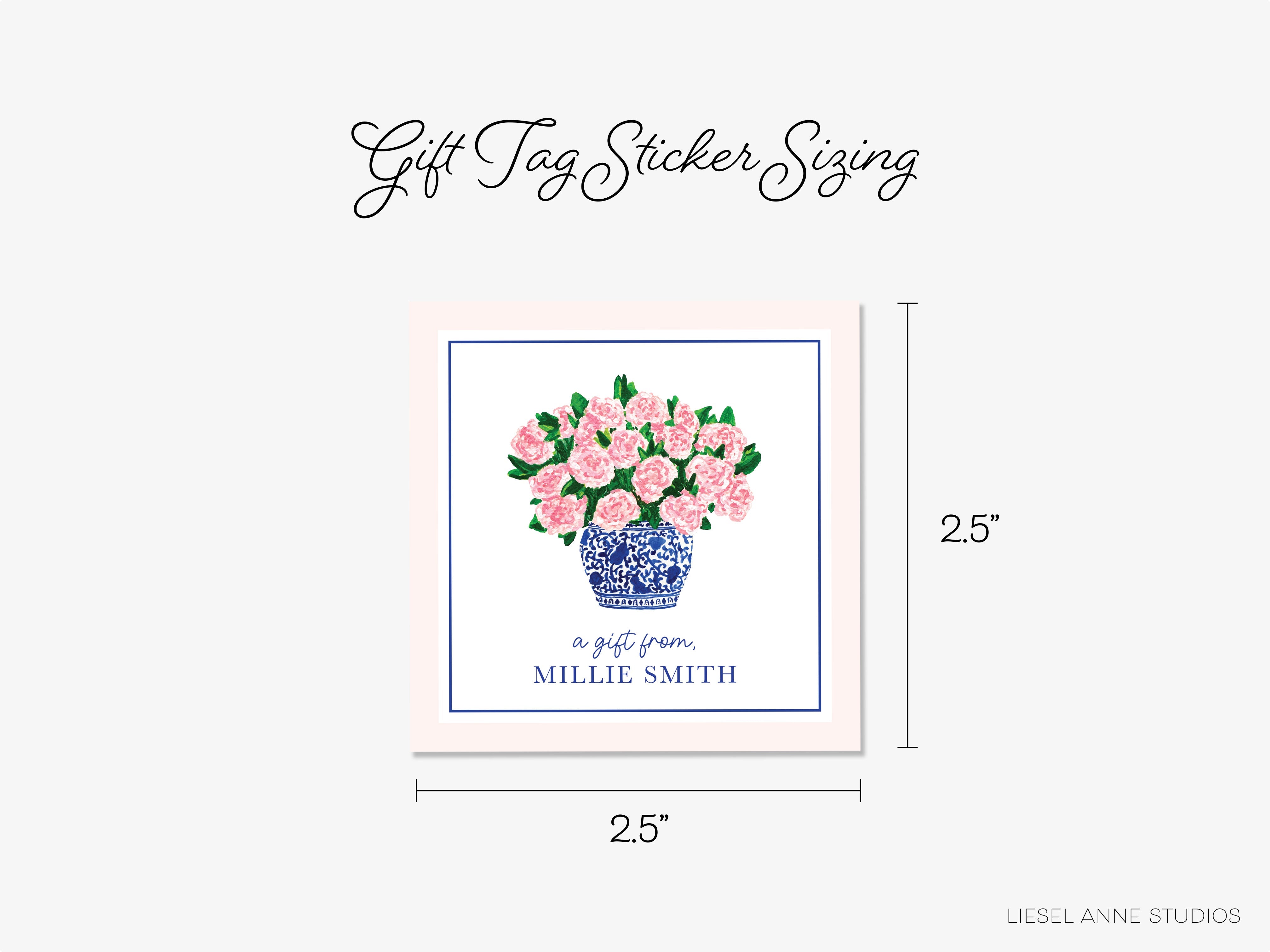 a blue and white vase with pink flowers on it