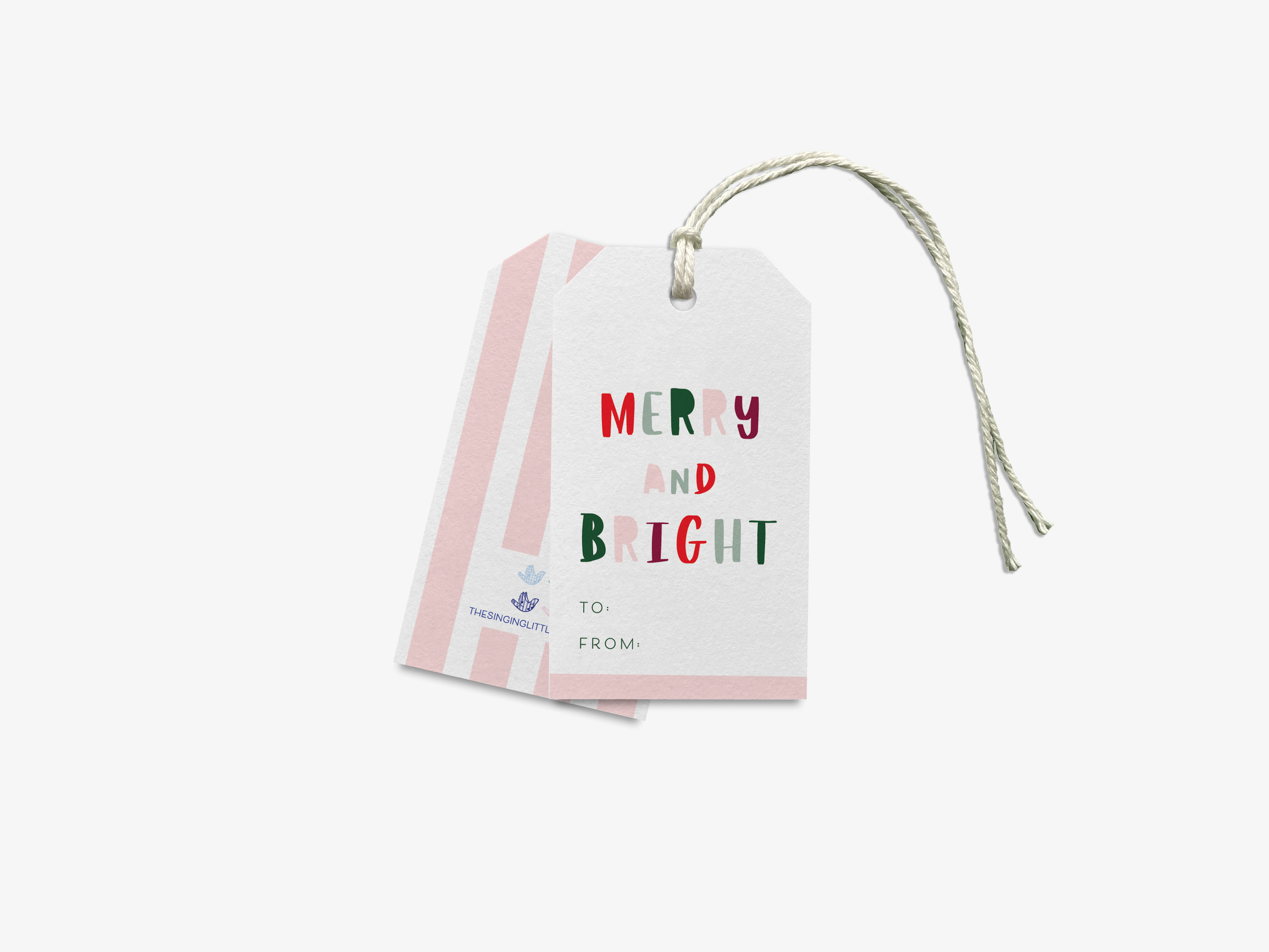 A white tag with pink stripes and the text "MERRY AND BRIGHT TO FROM" printed on it.