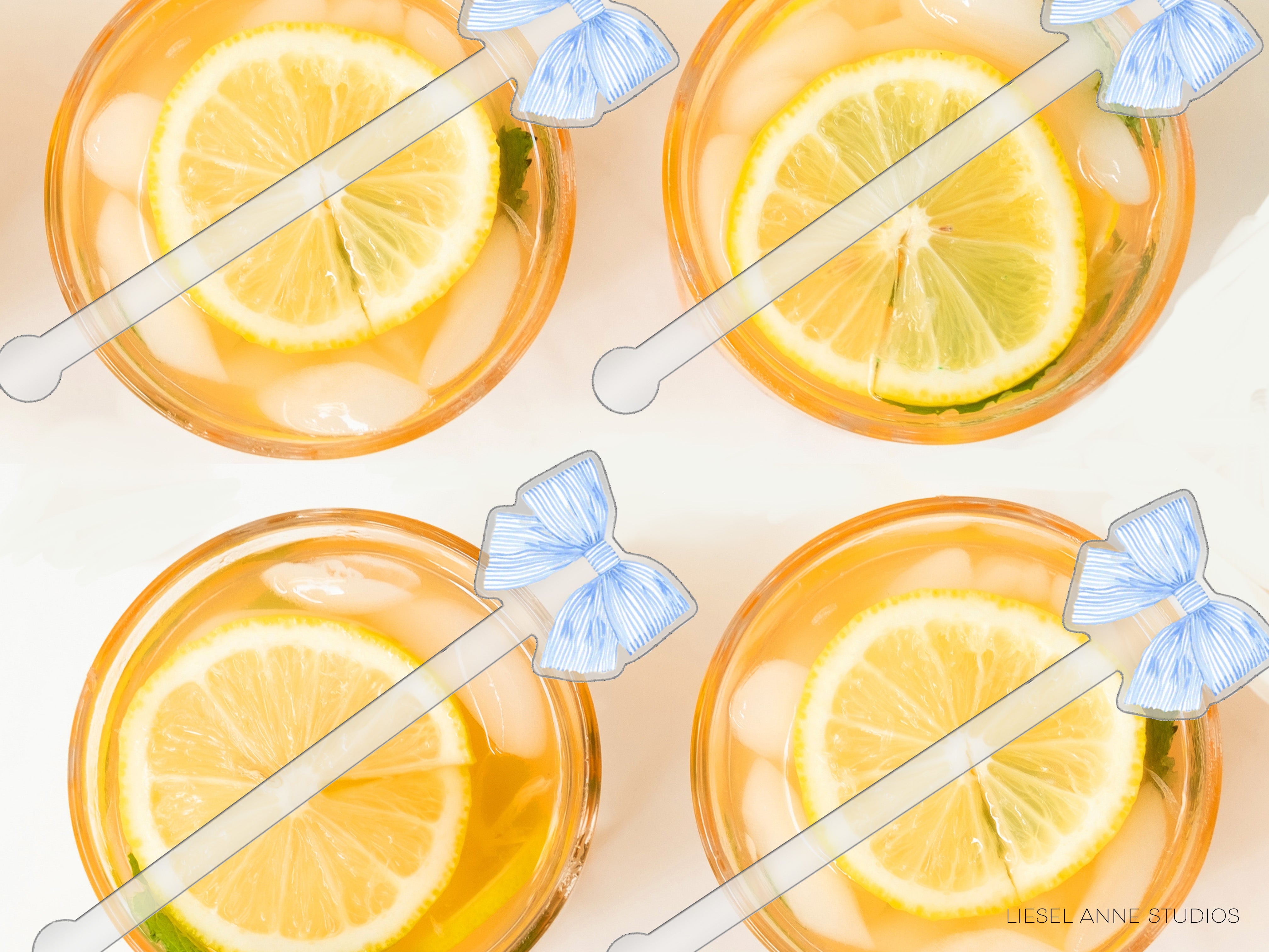 four glasses filled with a yellow liquid, each containing a slice of lemon. The glasses are accompanied by blue straws with white bows on top, adding a decorative touch to the presentation.