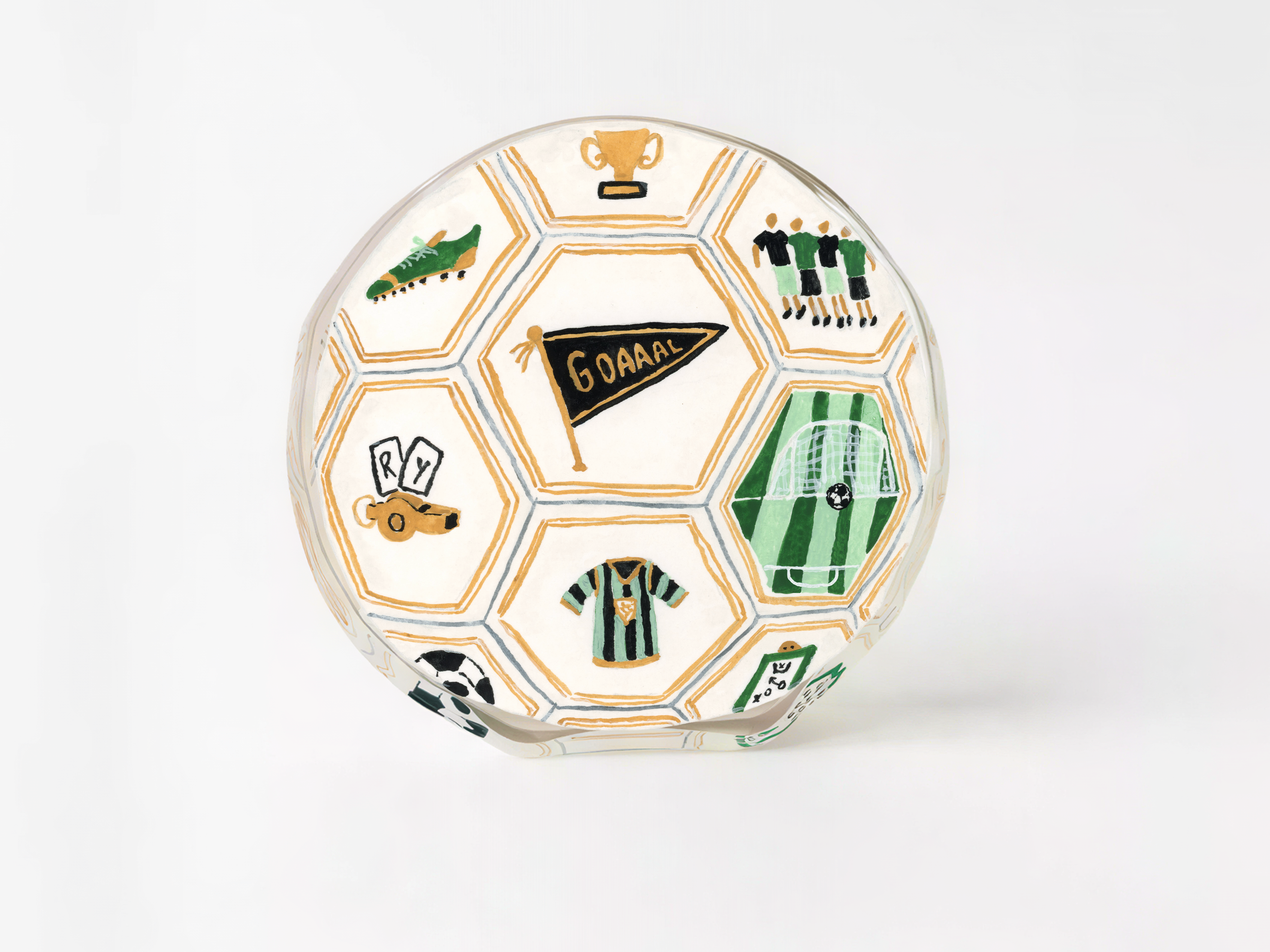 A soccer-themed glass trophy with various soccer-related icons and designs, including a soccer ball, players, a trophy, and a flag.