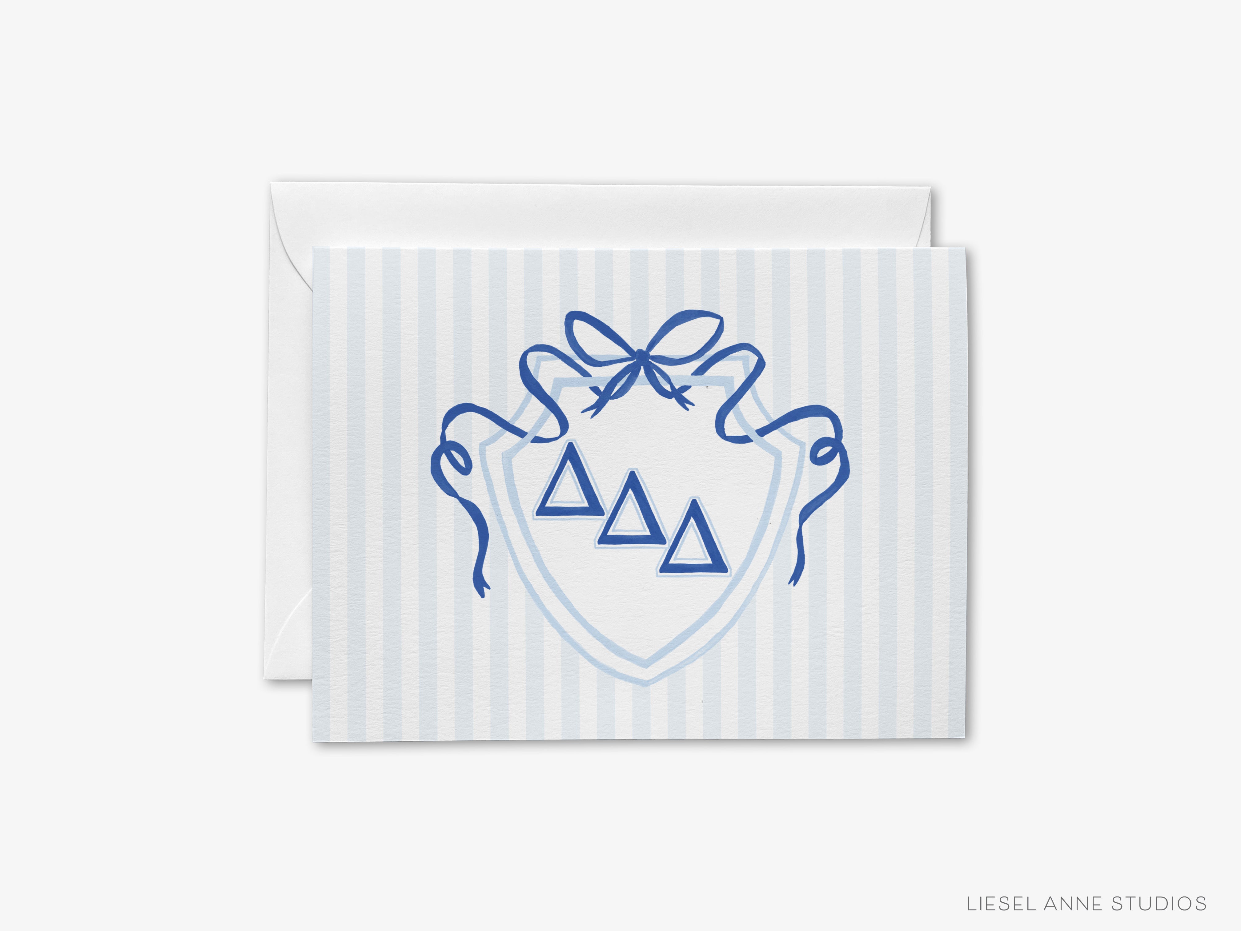 A greeting card with a shield design featuring three blue triangles and a blue ribbon bow.