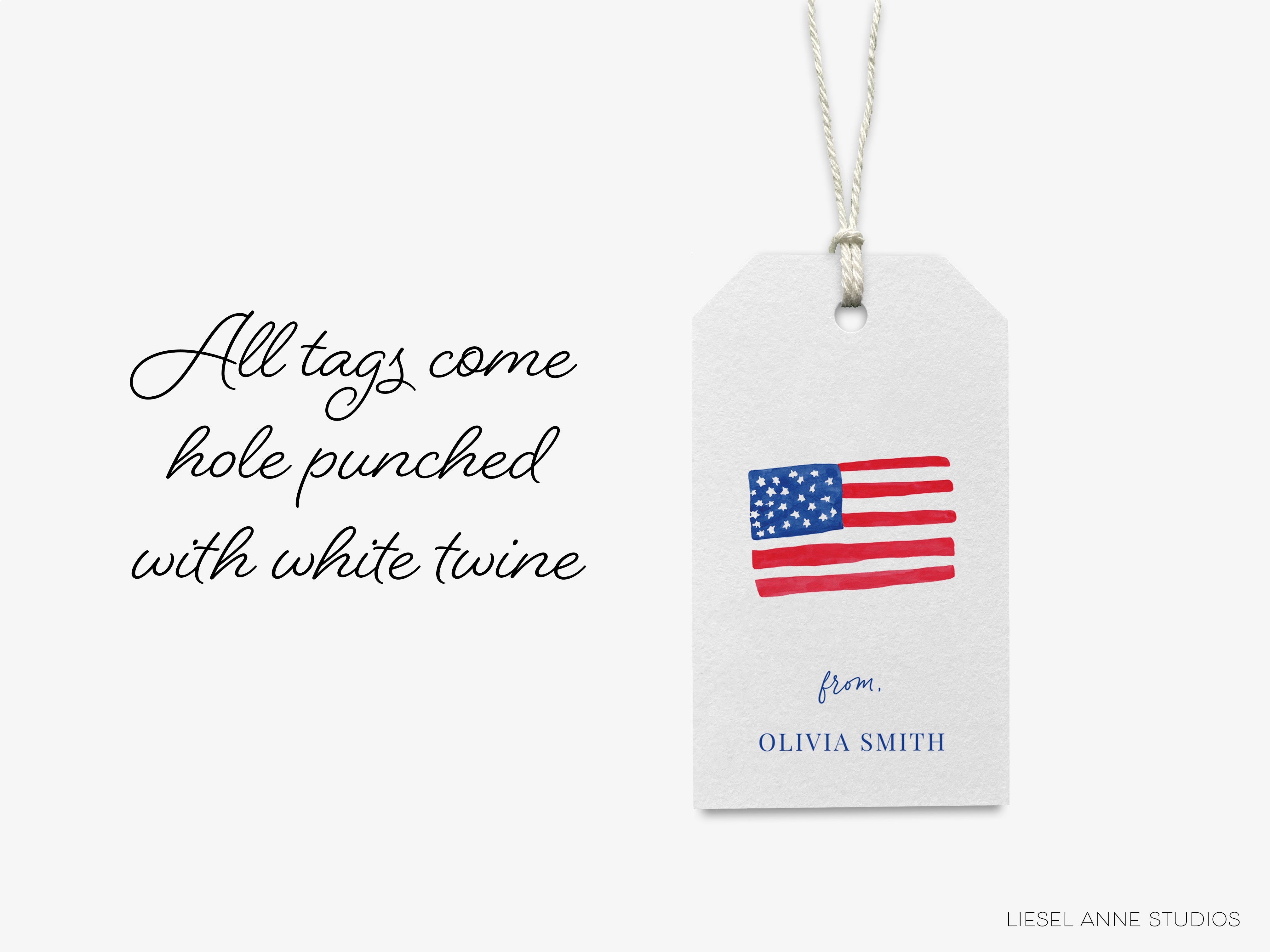 a white tag with a printed American flag and text, hanging from a string.