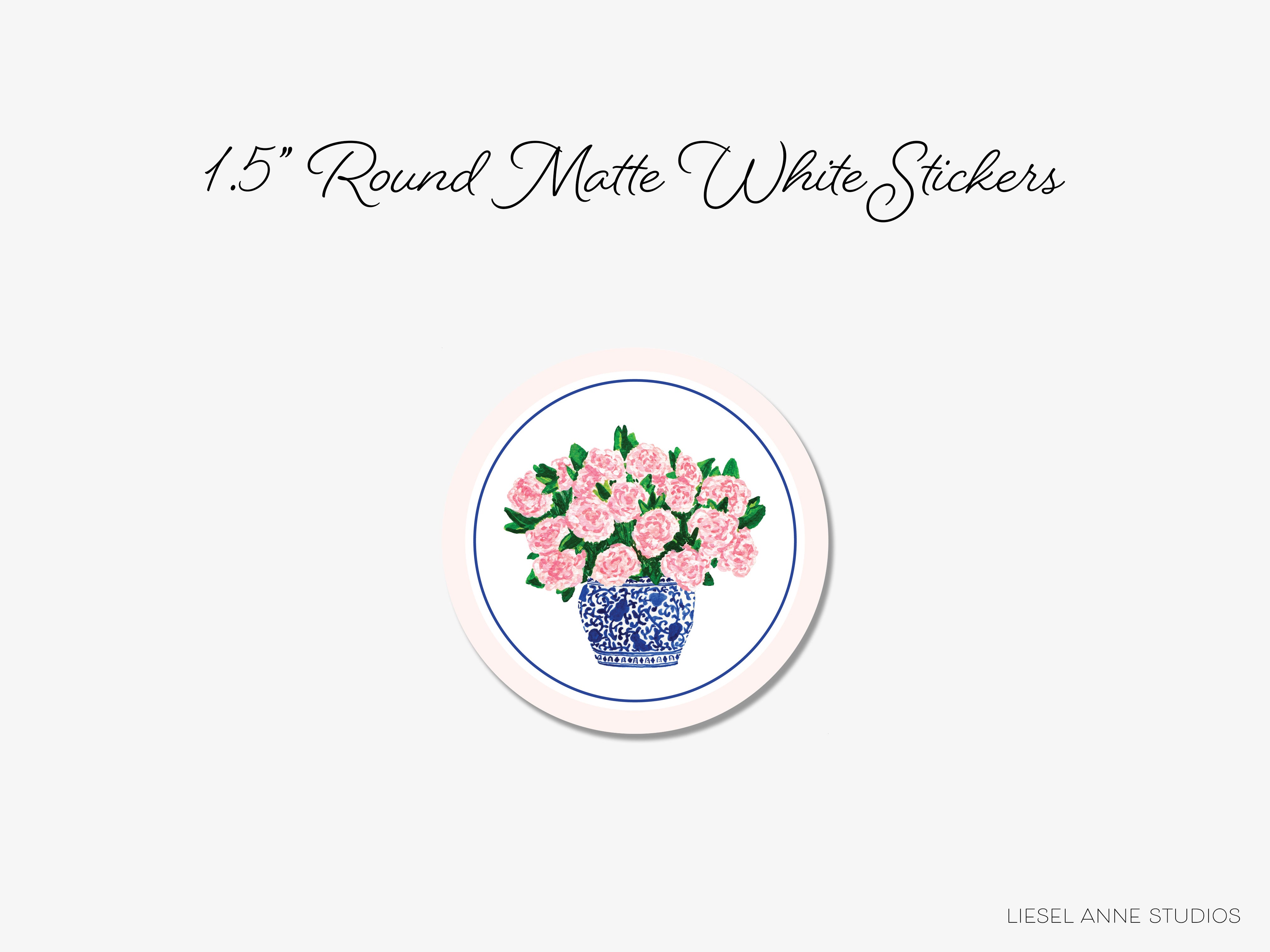 A round sticker with a blue and white china vase holding pink flowers.