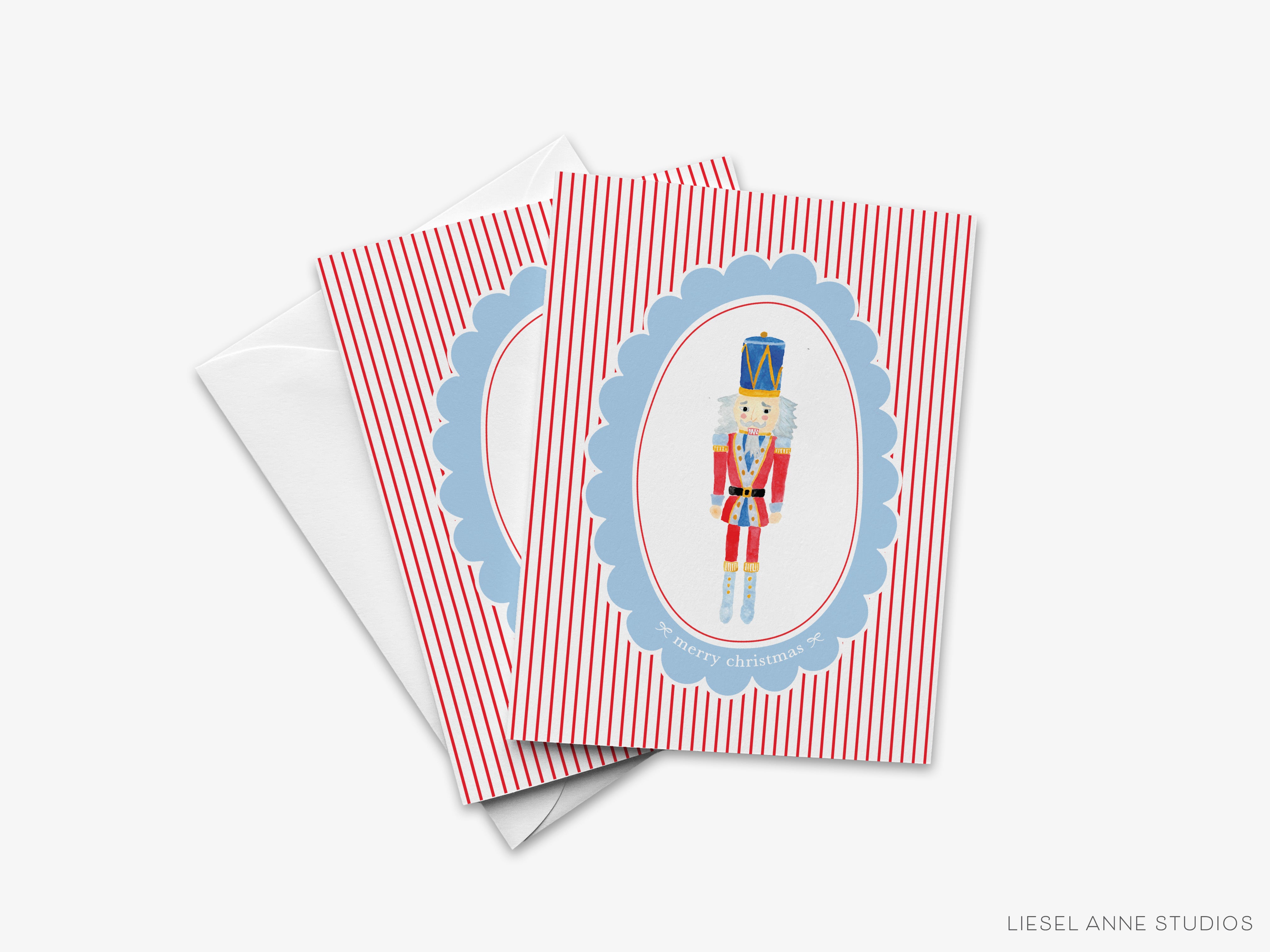 A set of greeting cards featuring a nutcracker figure in a blue oval frame with a red and white striped border.