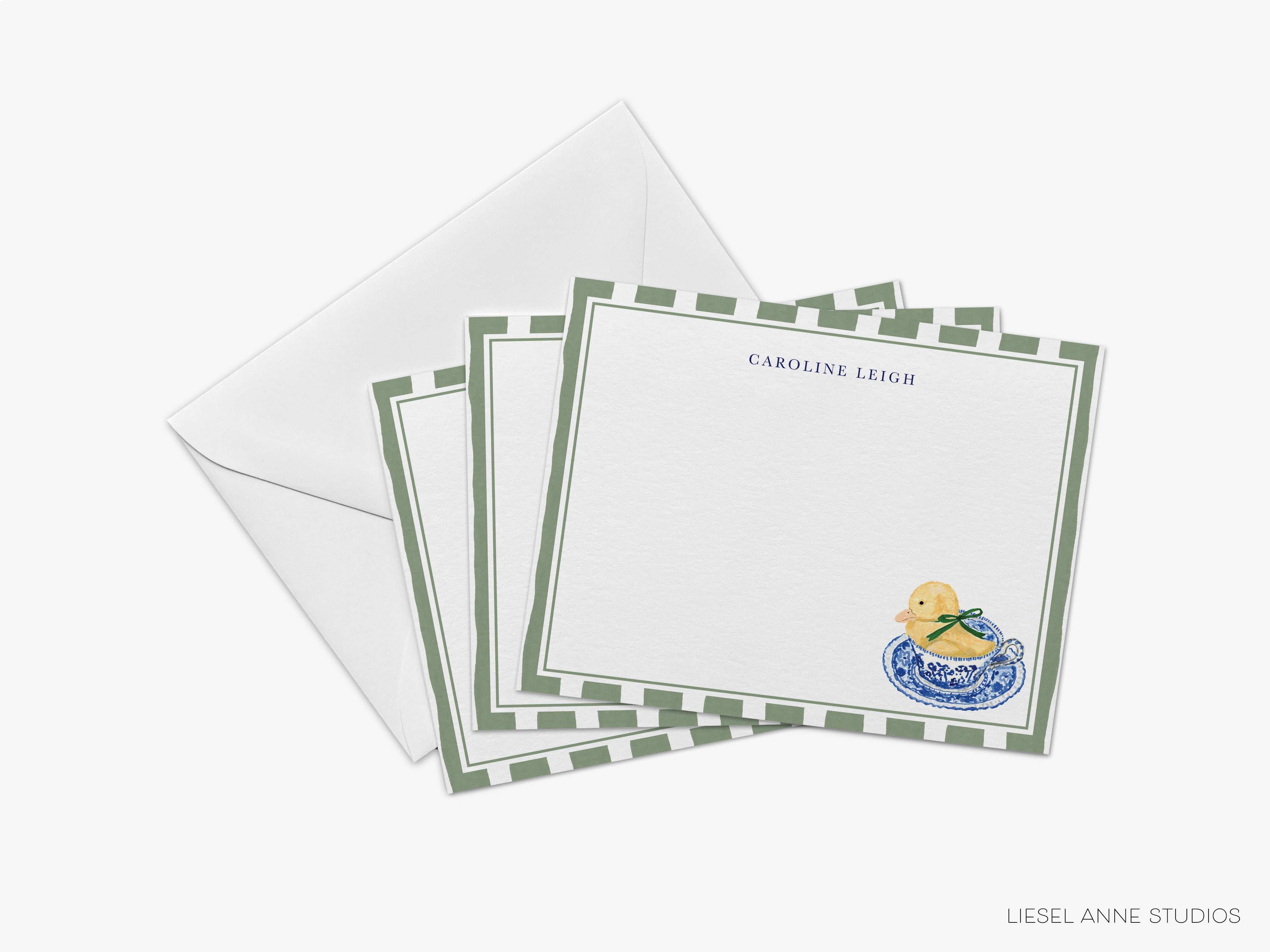a set of personalized stationery cards with a green and white striped border and a small illustration of a yellow duck on a blue and white plate.