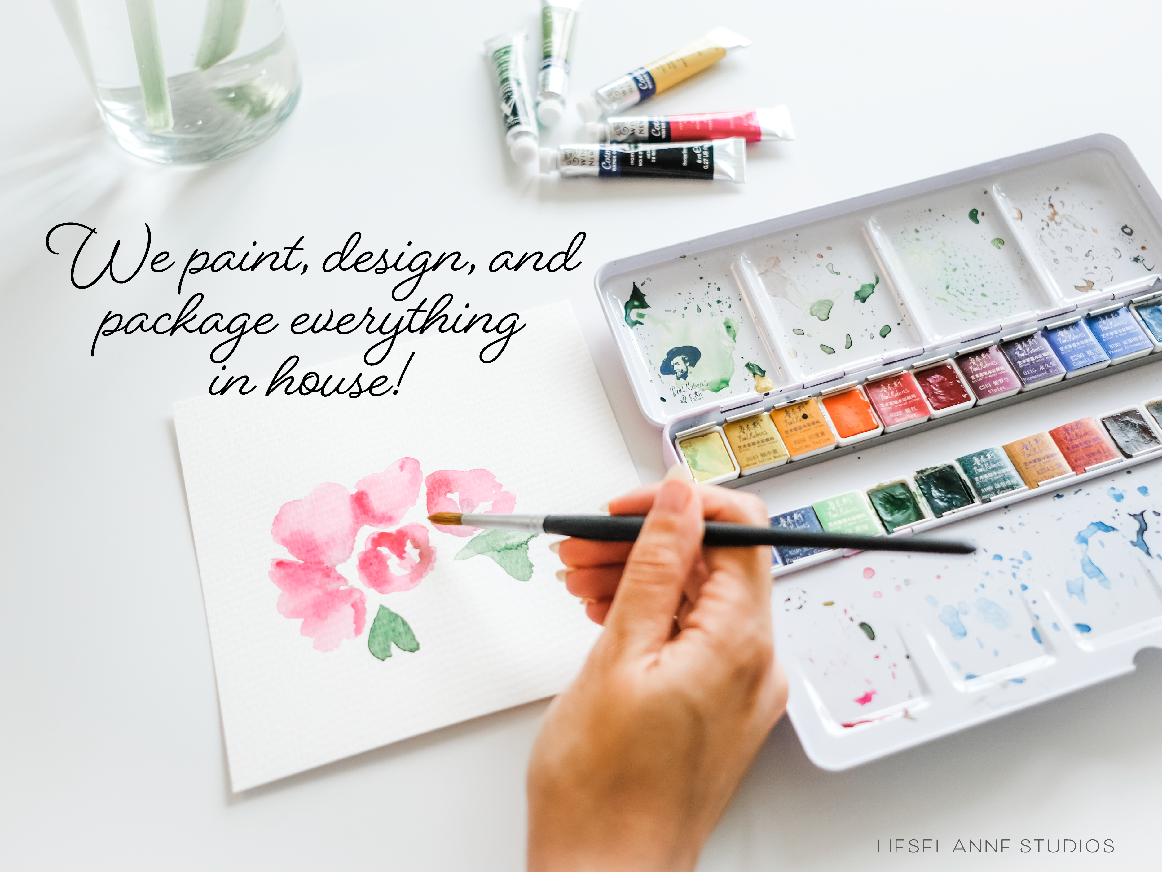a person is painting with watercolors on a table