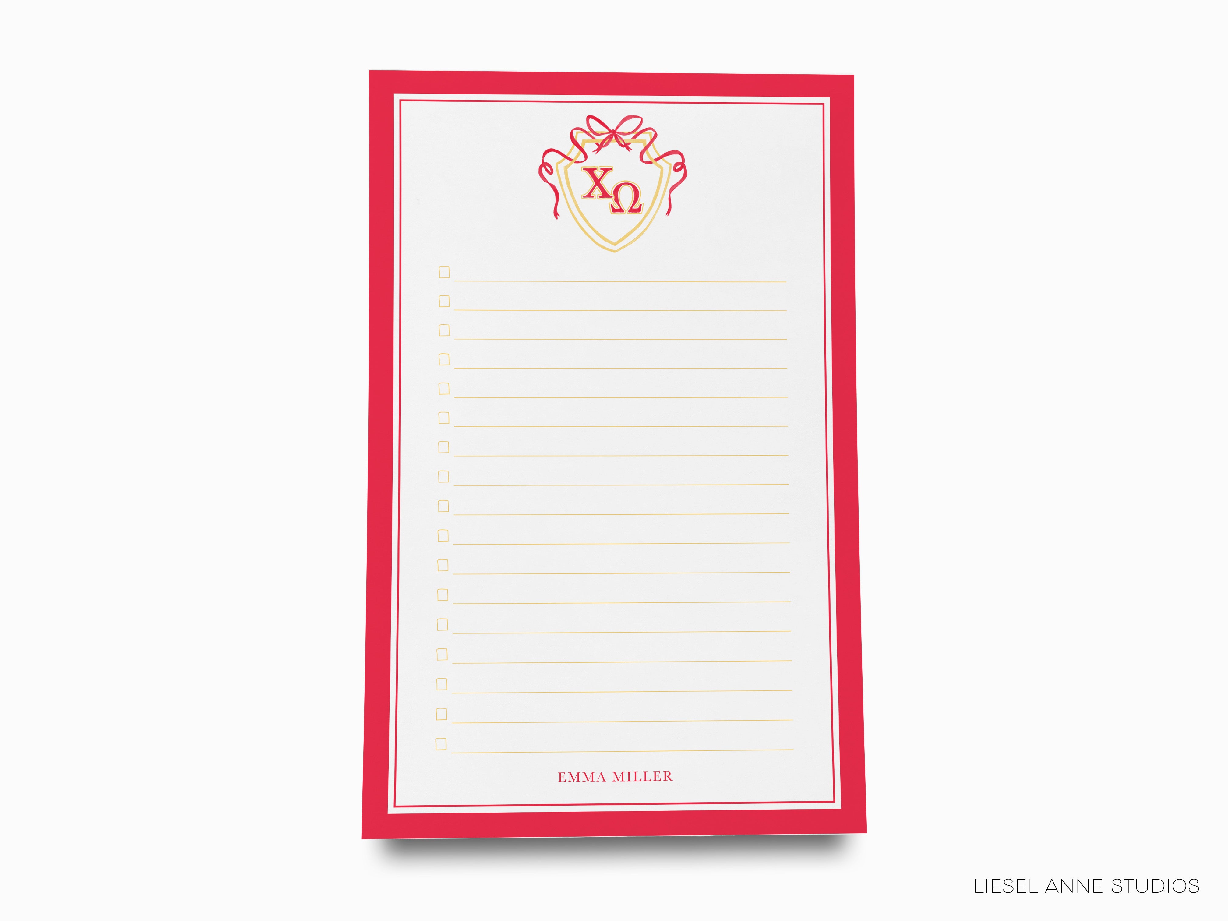a red and white notepad with a red bow on it