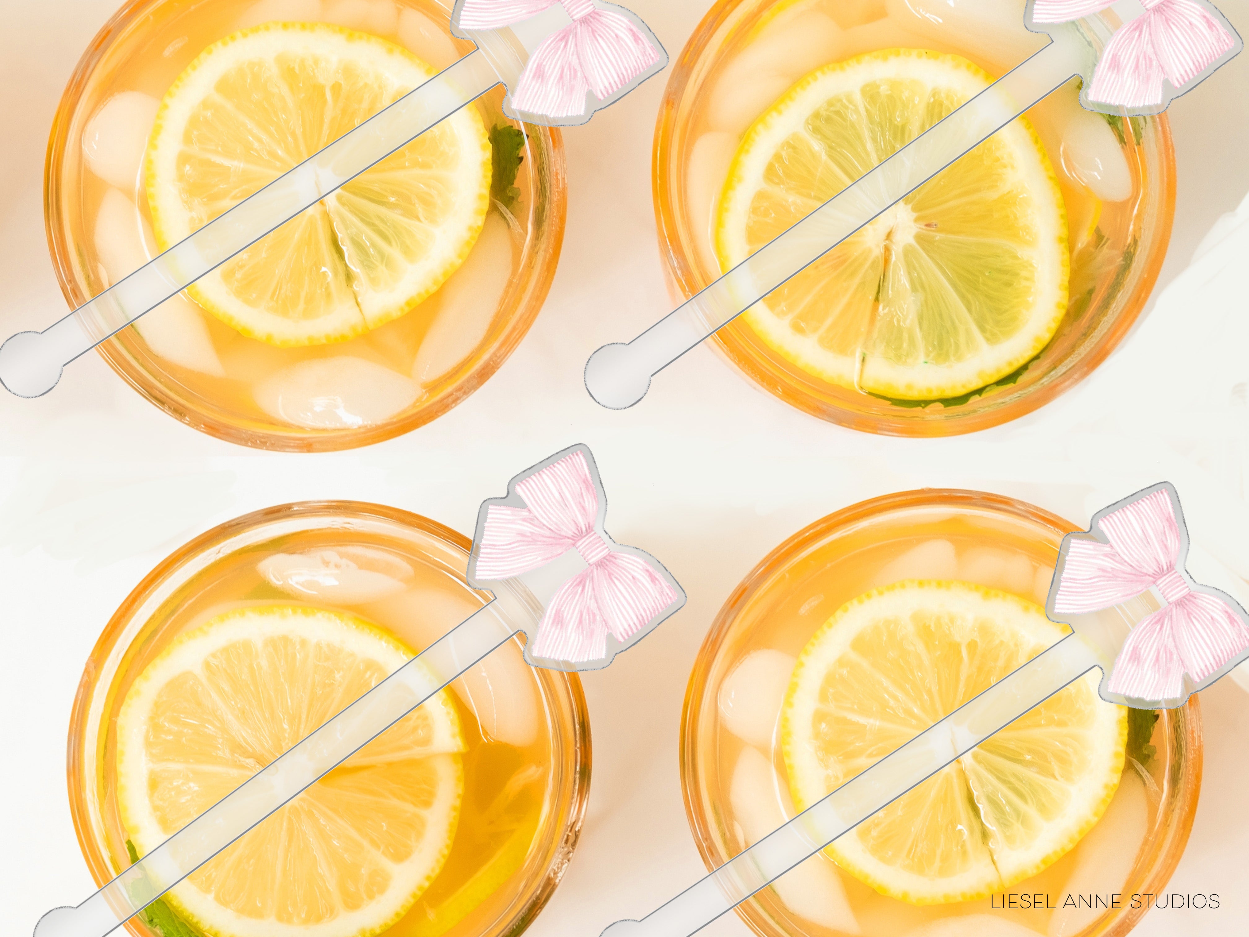 four glasses filled with a yellow liquid, each containing a slice of lemon. The glasses are accompanied by pink straws with white bows on them.