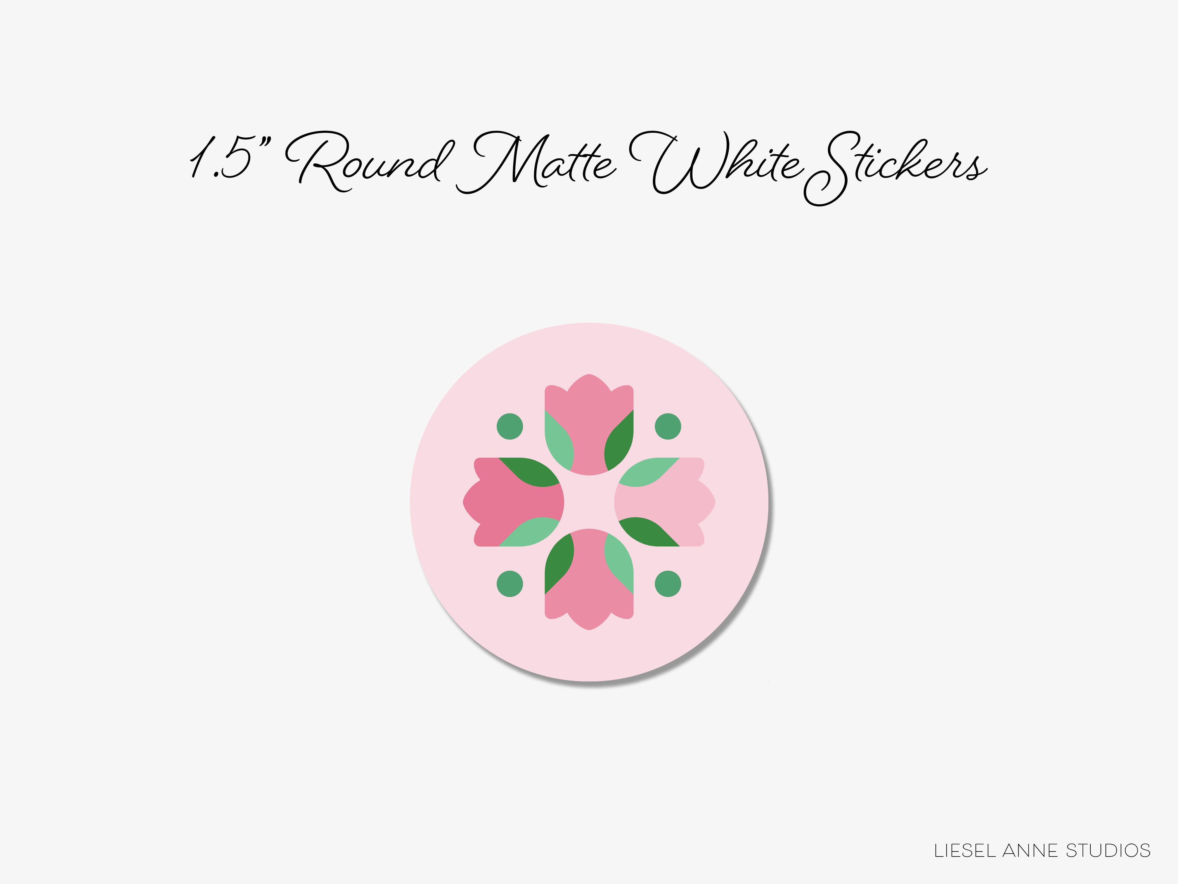 a pink circular sticker with a floral design.
