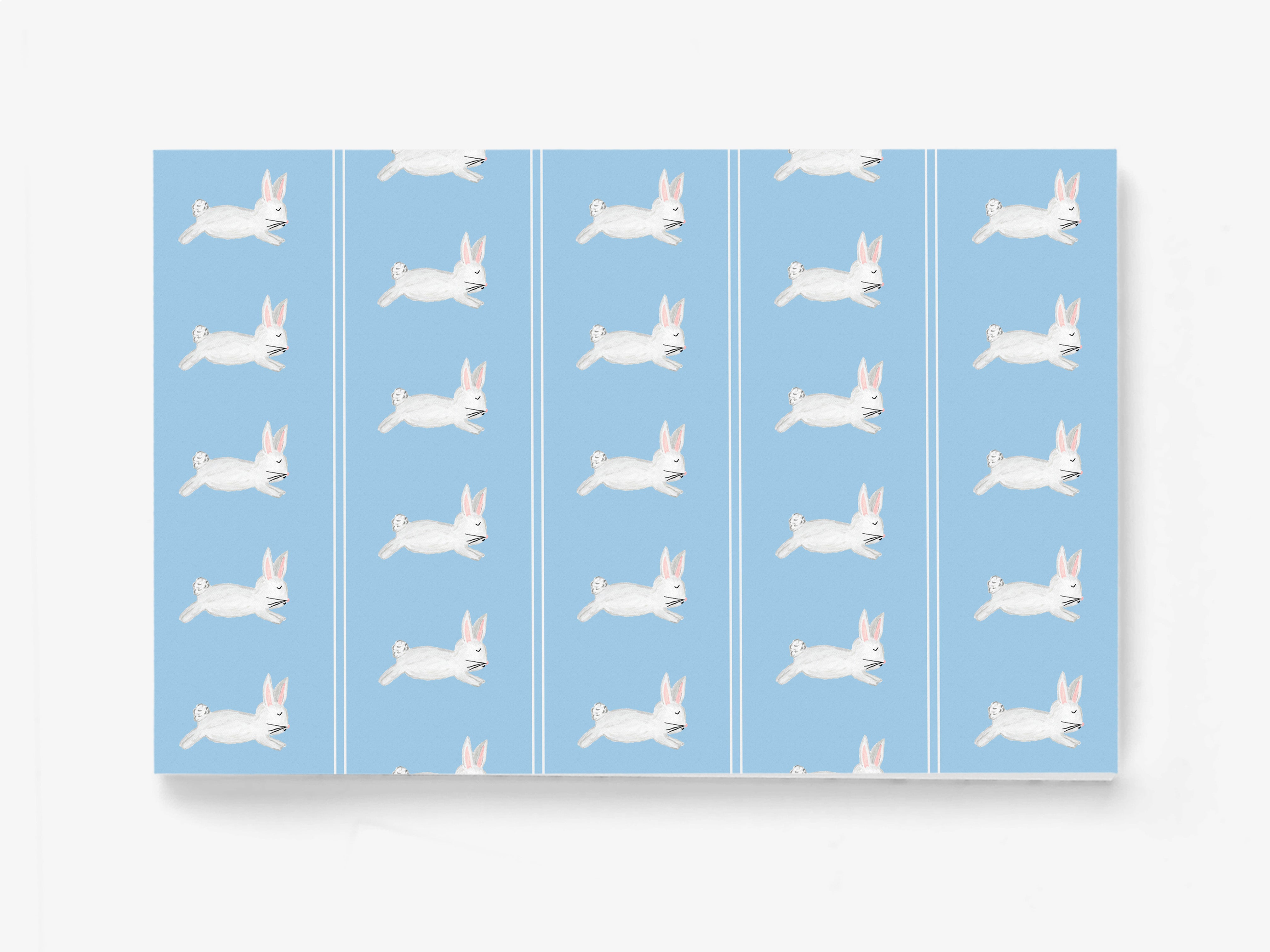 a repeating pattern of white rabbits against a light blue background.
