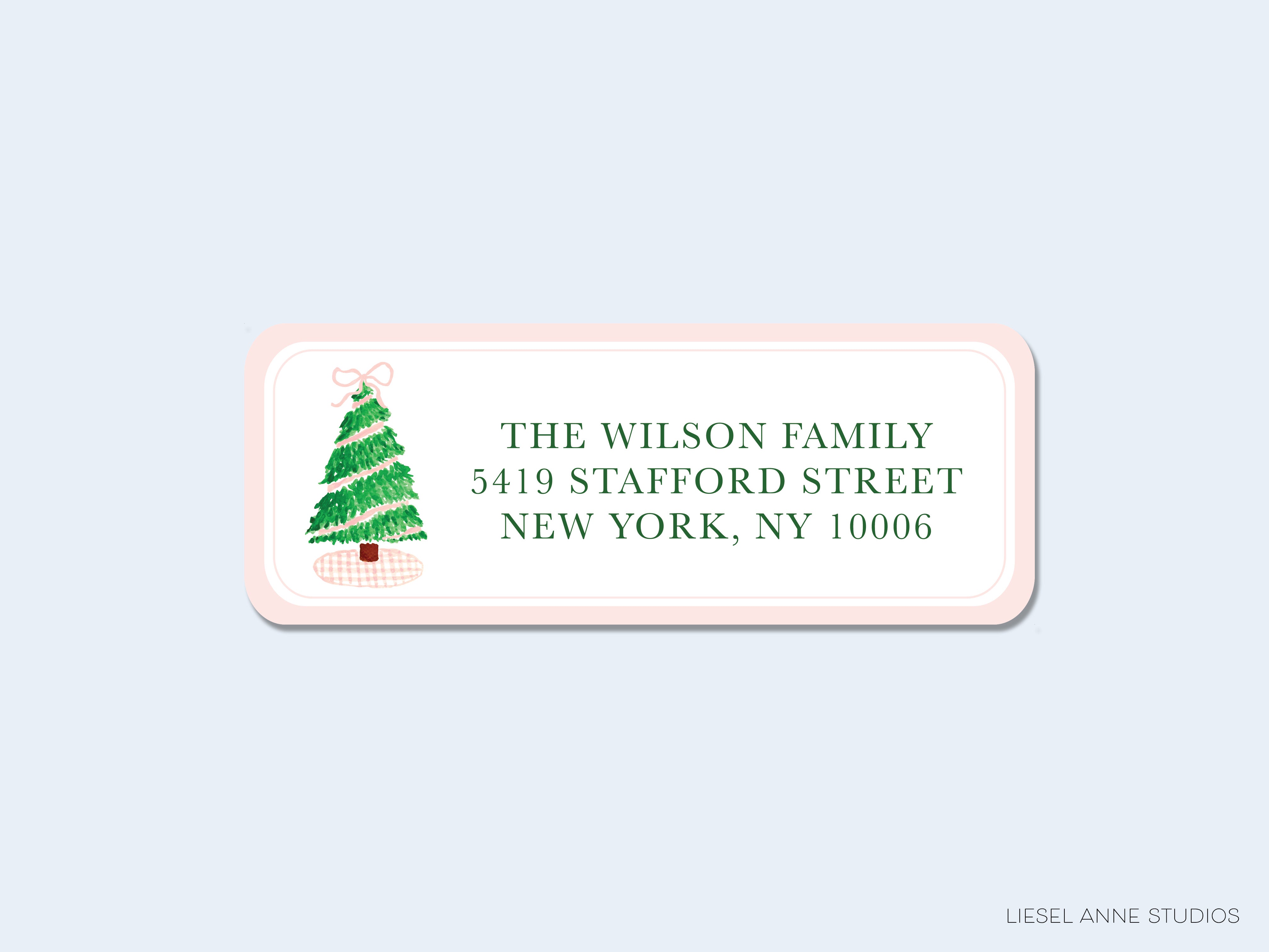 A pink envelope with a Christmas tree illustration and the address "The Wilson Family 5409 Stafford Street New York, NY 10006" printed on it.